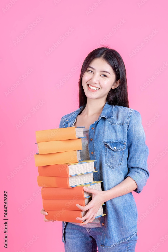 Portrait of a beautiful young woman student holding textbook - studying online e-learning system - education teenage concept Portrait of a beautiful young woman student holding textbook - studying online e-learning system - education teenage concept