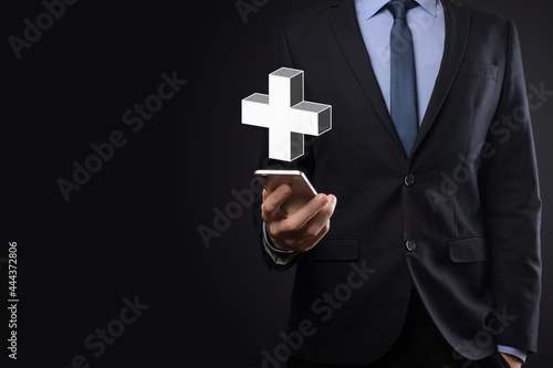 Businessman hold 3D plus icon, man hold in hand offer positive thing such as profit, benefits, development, CSR represented by plus sign.The hand shows the plus sign