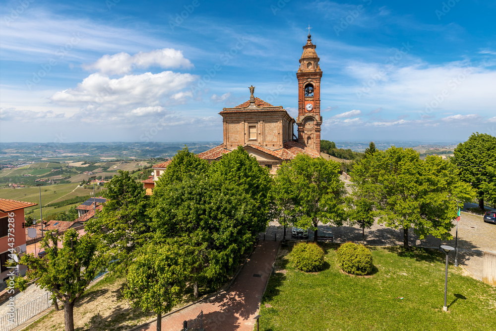 Old catholic church among green trees under beautiful sky in Piedmont, Italy. Old catholic church among green trees under beautiful sky in Piedmont, Italy.