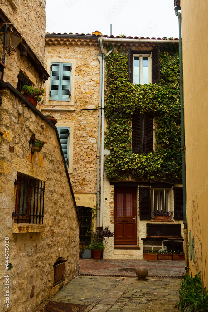 Narrow street in the historical part of town in France, Antibes. Popular travel destination for the sidewalk in town