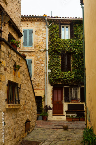 Narrow street in the historical part of town in France, Antibes. Popular travel destination for the sidewalk in town
