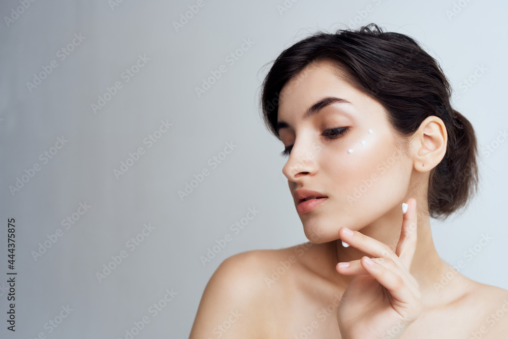 pretty brunette with bare shoulders face skin care health light background pretty brunette with bare shoulders face skin care health light background