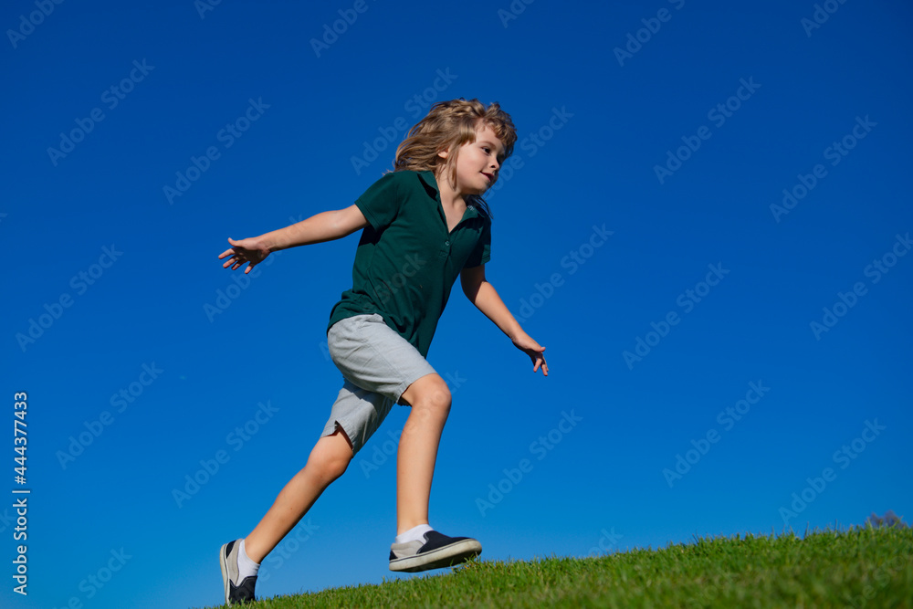 Child boy running on grass field and dreaming. Kids play on summer field. Active kids healthy outdoor. Fun activity. Child boy running on grass field and dreaming. Kids play on summer field. Active kids healthy outdoor. Fun activity.