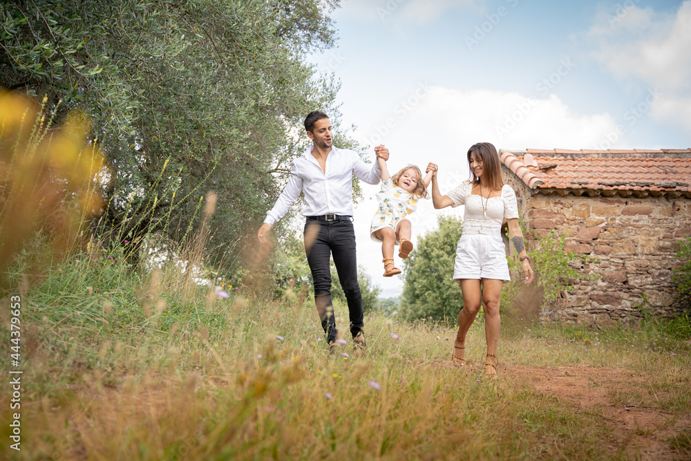 Happy family together, parents raising baby up in the air. Happy family together, parents raising baby up in the air.