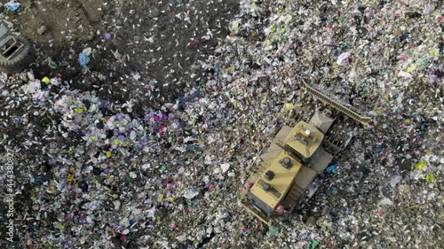 Bulldozer reversing over huge landfill site  photo