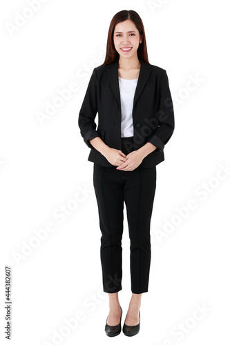Full body portrait of asian beautiful business working long hair woman wearing formal black suit and high heel shoes, smiling, confident smart posing, standing on isolated white background cutout.