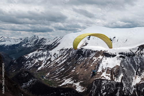 paraglider in the air over mountains