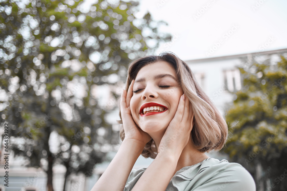 cheerful pretty woman close-up on the street in summer cheerful pretty woman close-up on the street in summer