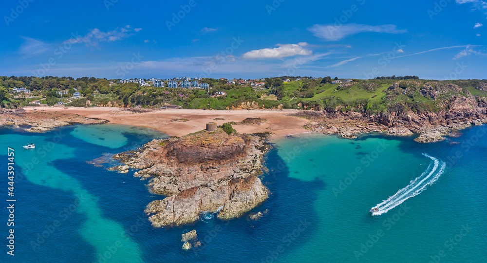 Aerial Drone image of Portelet Bay, Jersey, Channel Islands with blue sky and calm water.