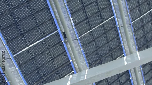 Rotating low-angle shot over big solar panel structure. Back view of solar cells.