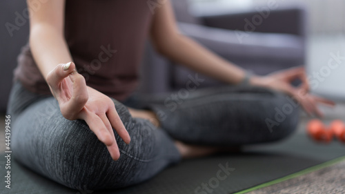 a lively girl doing meditate to keep calm mind and being relaxed as her indoor activity