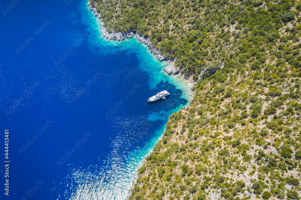 Aerial view of lonely yacht boat in secluded remote beach on the Ionian island of Kefalonia, Greece