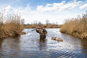 the hunter pulls the tied plastic dummy ducks