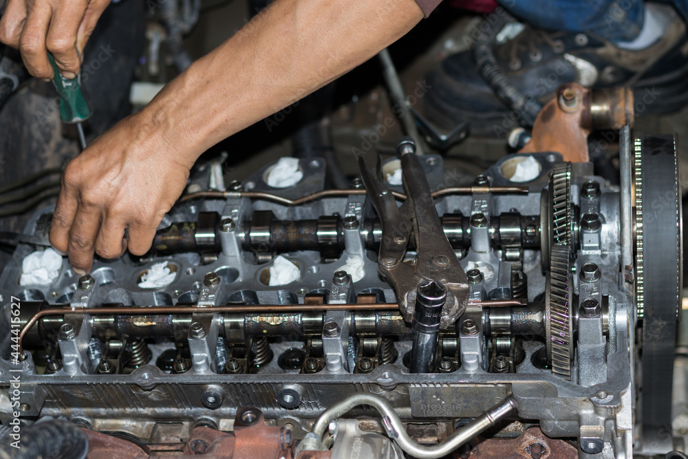 The mechanic is checking the engine. The mechanic is checking the engine.