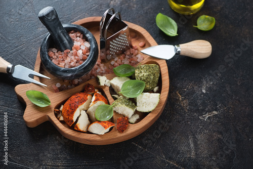 Wooden serving tray with swiss belper knolle cheese over dark brown stone background, elevated view, horizontal shot photo