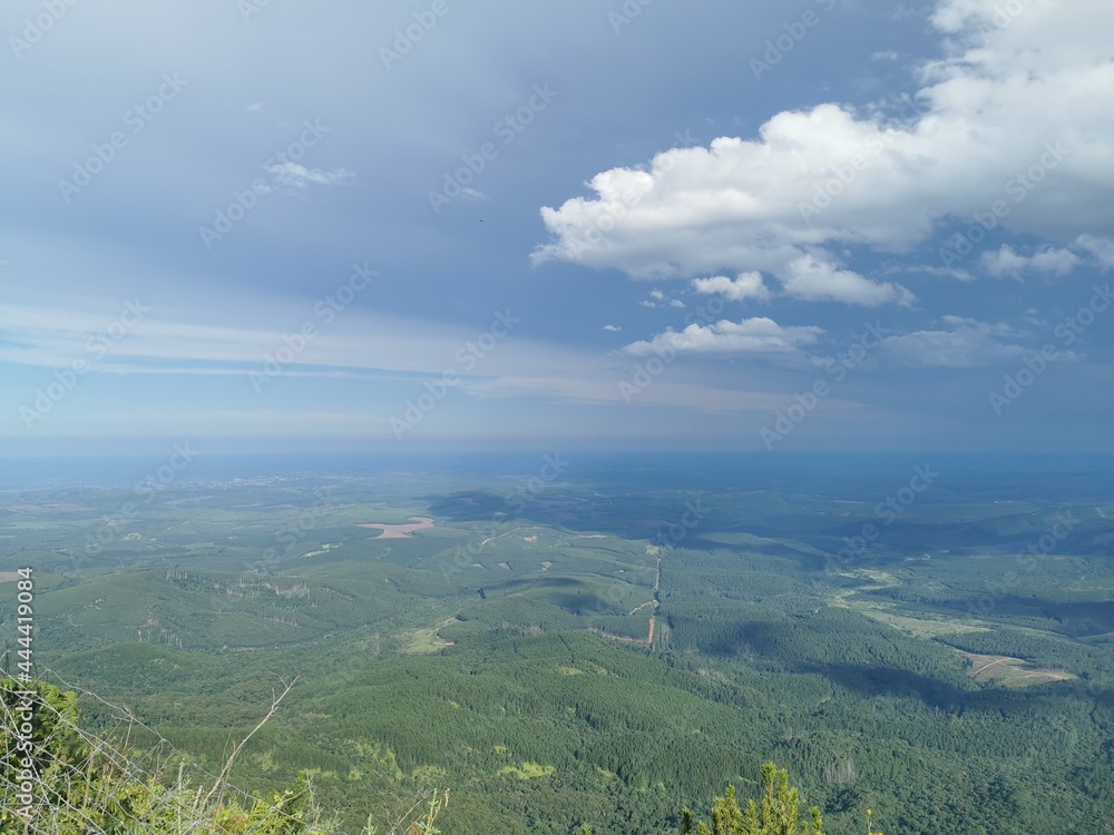 Fototapeta premium Green valley blue sky gods window Lush greenery clouds