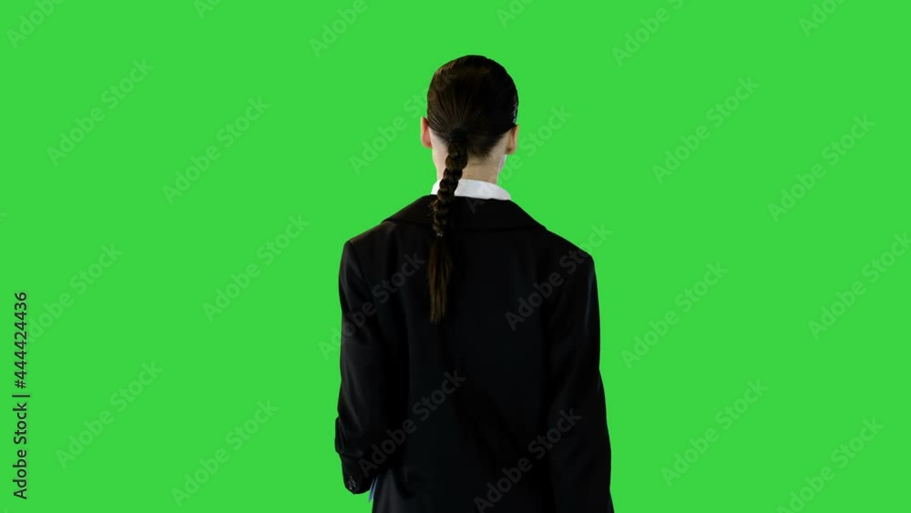 Woman in office suit walks with documents in her hands on a Green Screen, Chroma Key. Woman in office suit walks with documents in her hands on a Green Screen, Chroma Key.