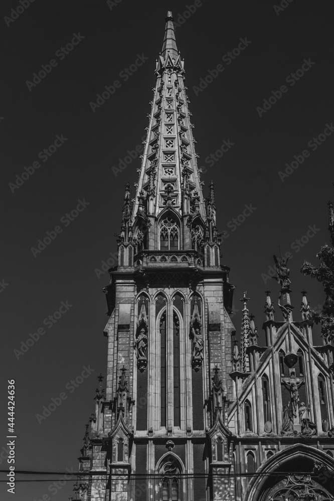 Black and white photo of old catholic church. Cathedral in black and white colours in sunny day. Peak of catholic church roof. Saint Nicholas Cathedral in Kyiv, Ukraine