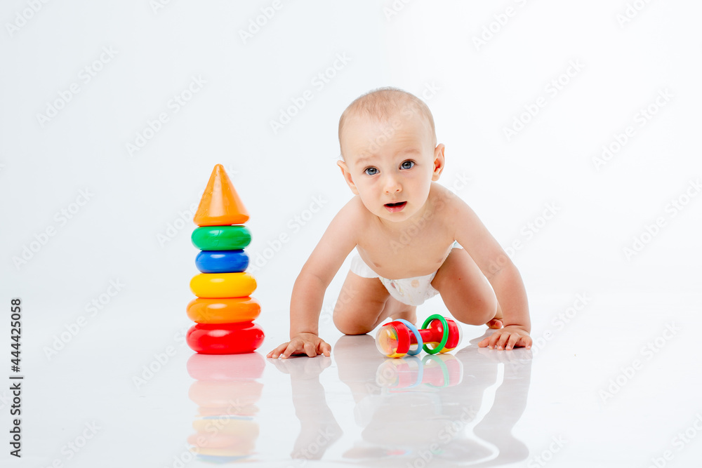 a baby boy with a multi-colored pyramid is isolated on a white background; a baby boy with a multi-colored pyramid is isolated on a white background;