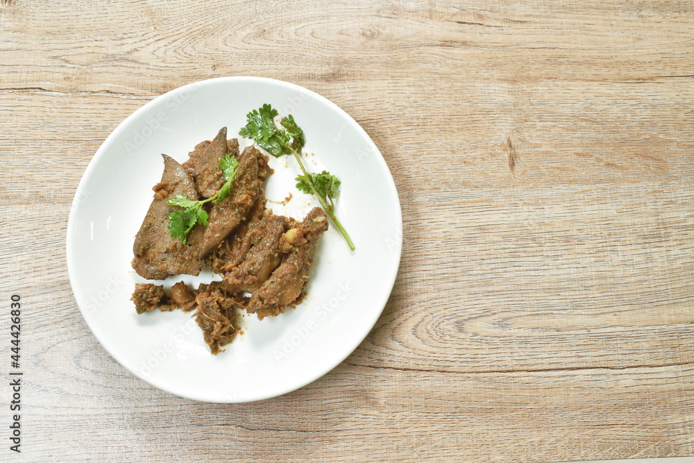 fried slice pork meat and liver with garlic couple pepper topping parsley on plate fried slice pork meat and liver with garlic couple pepper topping parsley on plate