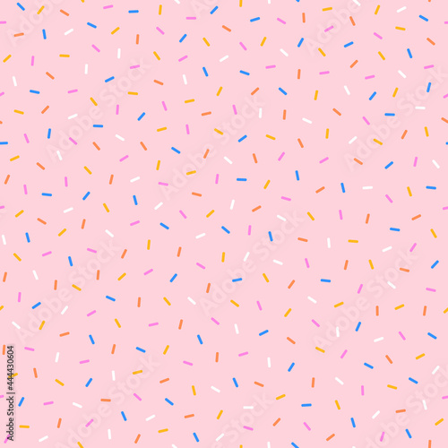 Sweet colorful sprinkling on a pink background. 