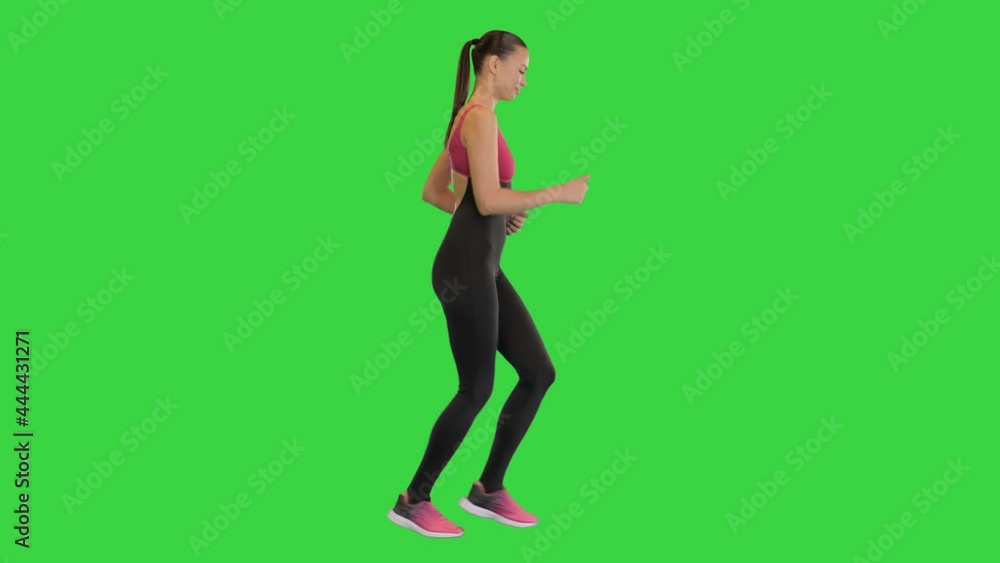 Confident beautiful fit girl jogging on a Green Screen, Chroma Key. Confident beautiful fit girl jogging on a Green Screen, Chroma Key.