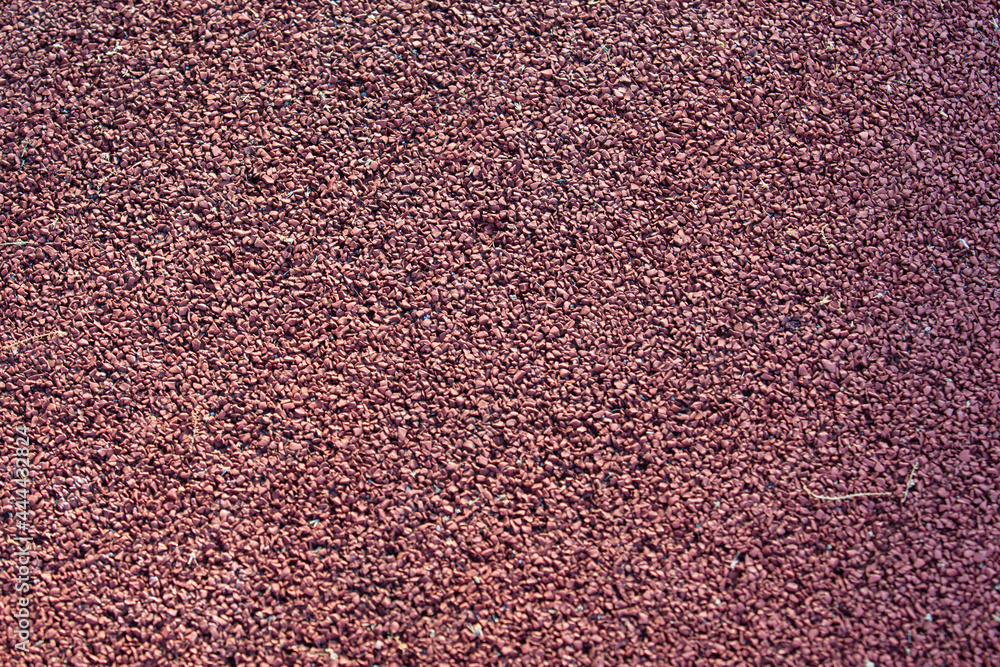 The texture of burgundy rubber asphalt on the playground. Self-leveling coating for a playground The texture of burgundy rubber asphalt on the playground. Self-leveling coating for a playground