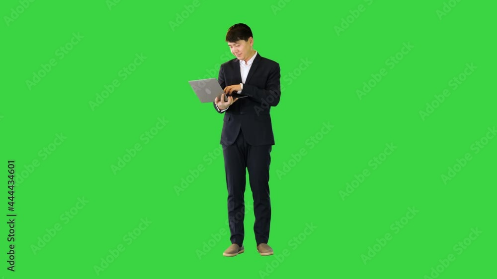 Asian man working with laptop on a Green Screen, Chroma Key. Asian man working with laptop on a Green Screen, Chroma Key.