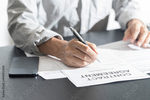 Business man signing document. Business man signing contract. Close up of business manager signing document on table.