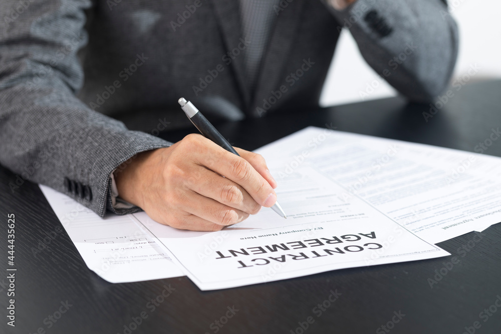 Business man signing document. Business man signing contract. Close up of business manager signing document on table. Business man signing document. Business man signing contract. Close up of business manager signing document on table.