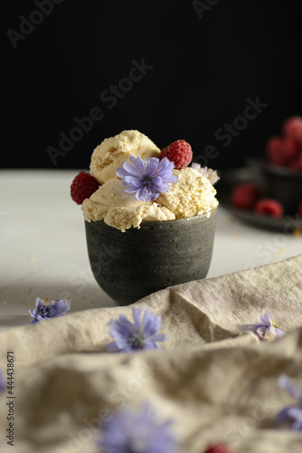 ice cream in a ceramic bowl with raspberries