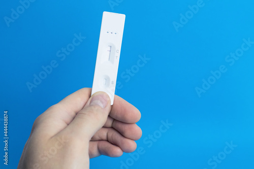 Coronavirus (COVID-19) rapid lateral flow test in hand. Rapid antigen test. COVID-19 Self-Test.