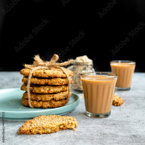 Konstfotografi Multigrain Cookies with Glass of Tea  - styled with jar of oatmeal
