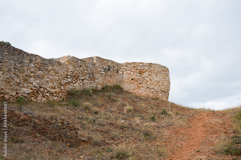 Ancient walls of a castle at Merindades, Burgos, Spain, Europe. Cloudy day, no people