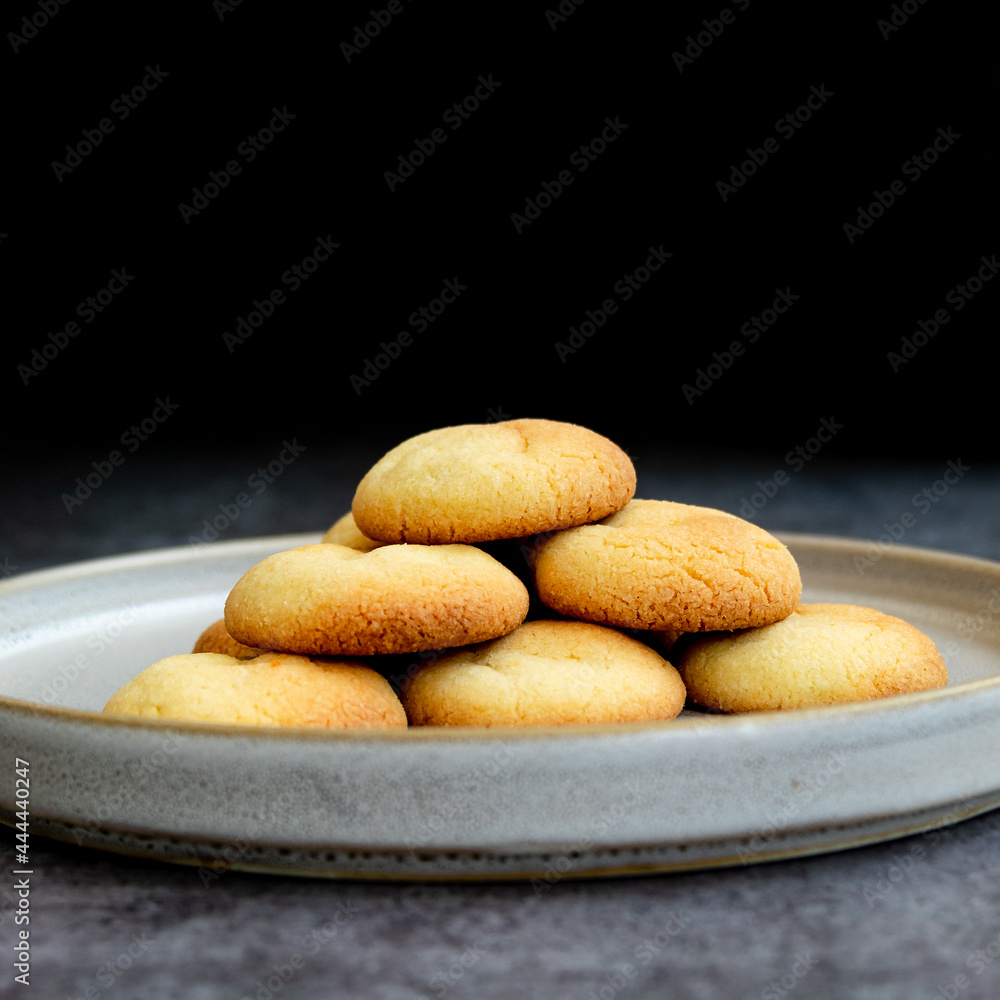 Almond and Orange Cookies isolated in black background