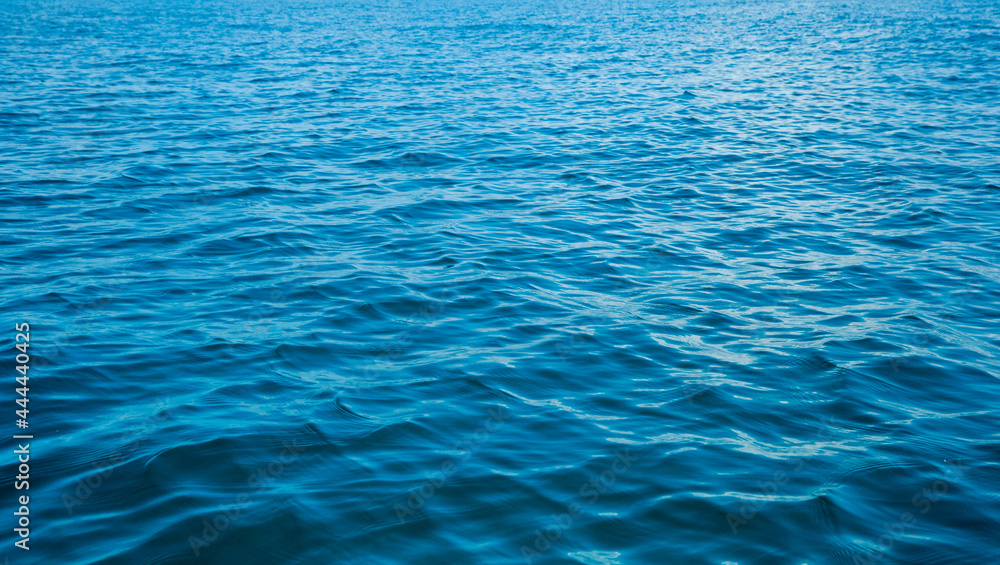 Blue water with sun reflections Blue water with sun reflections