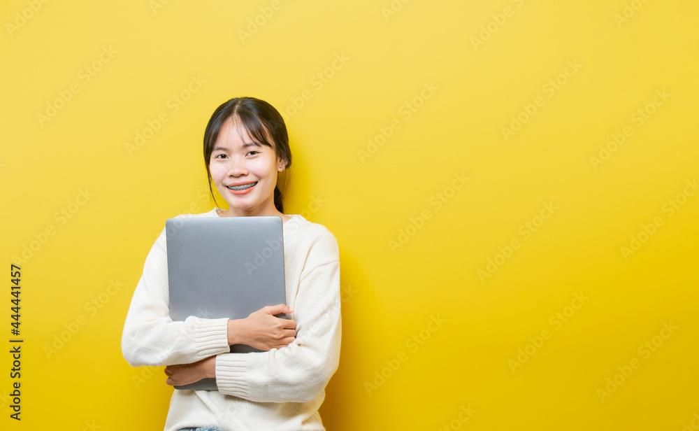 Full length body size turned photo of cheerful positive cute nice attractive blogger browsing through her laptop Full length body size turned photo of cheerful positive cute nice attractive blogger browsing through her laptop