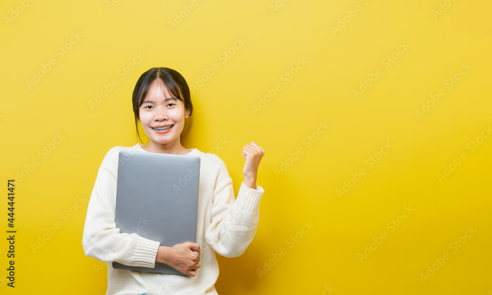 Full length body size turned photo of cheerful positive cute nice attractive blogger browsing through her laptop Full length body size turned photo of cheerful positive cute nice attractive blogger browsing through her laptop