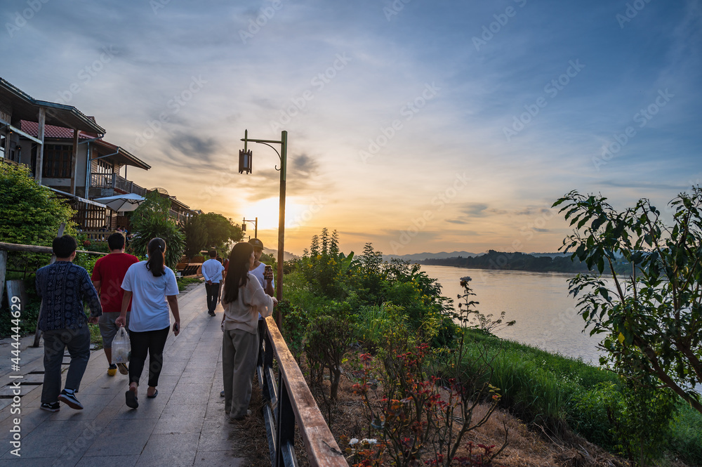 Unacquainted People walking on Chiang khan riverside with landscape view of maeklong river at loei thailand.Chiang Khan is an old town and a very popular destination for Thai tourists