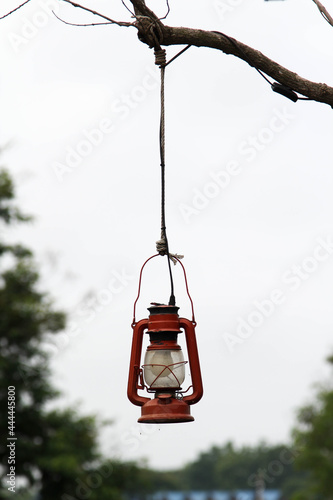 Red oil lamp hanging on branches.