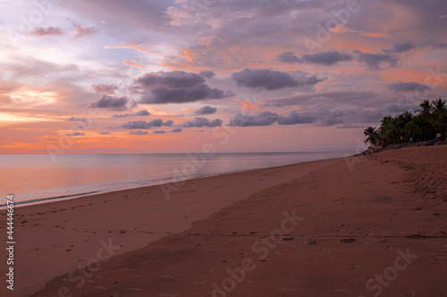 beautiful soft orangeand pink sun light sunset in sea behind island. soft golden sand beach calm and romantic place in thailand