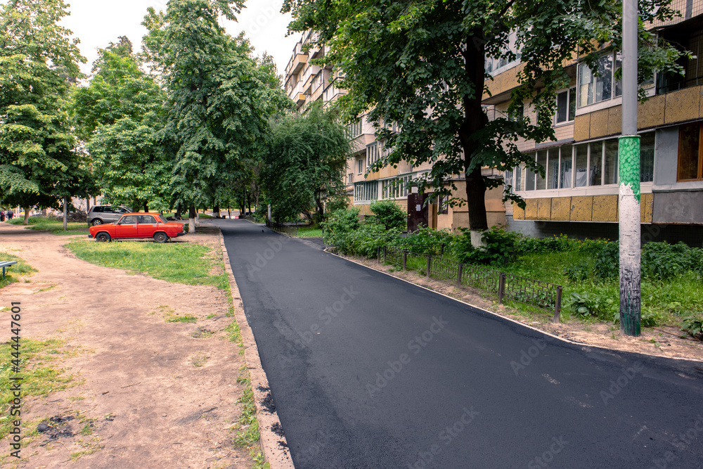 Freshly paved asphalt in the courtyard of a residential multi-storey building