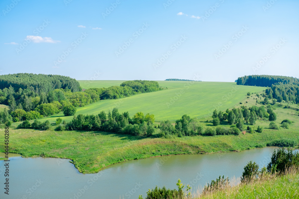 Beautiful summer landscape Forests on the hill and lakes. Summer green countryside nature landscape. The lake under the forest.