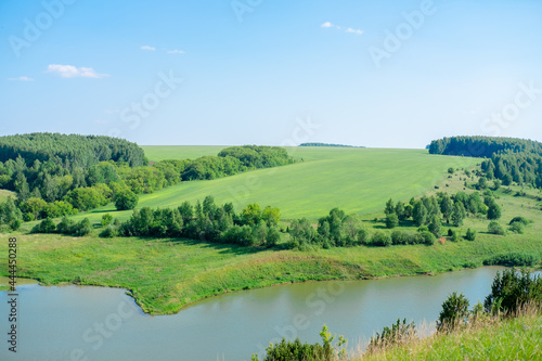 Fototapeta Naklejka Na Ścianę i Meble -  Beautiful summer landscape Forests on the hill and lakes. Summer green countryside nature landscape. The lake under the forest.