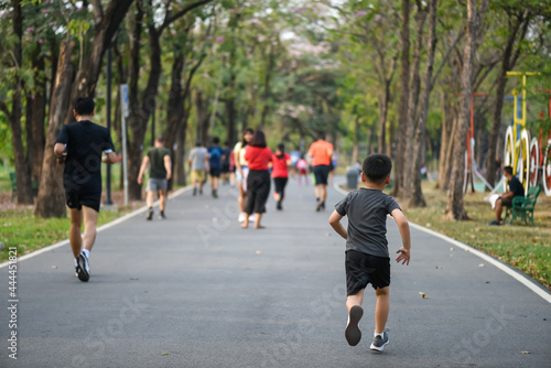 Little fit Asian boy run in park