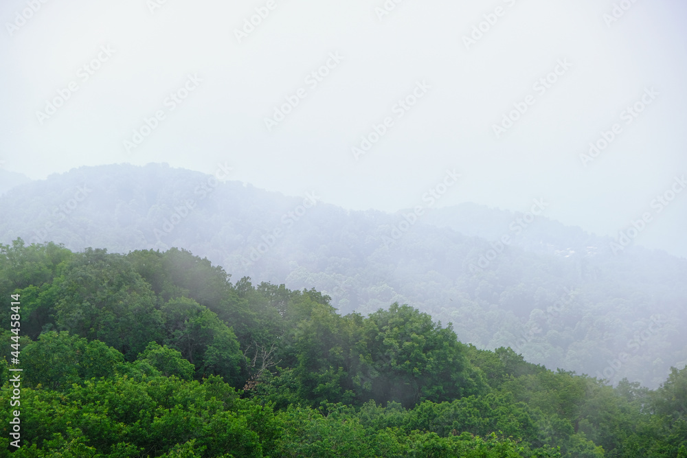 View of mountains and forest from above, mountain Akhun hills and forest in the morning fog