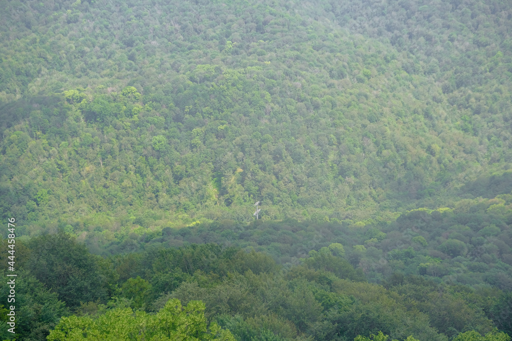 Obraz premium View of mountains and forest from above, mountain Akhun hills and forest in the morning fog