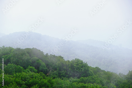 View of mountains and forest from above, mountain Akhun hills and forest in the morning fog photo