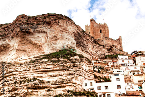 Overview of Alcala del Jucar village in spring under gray sky photo