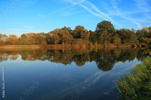Landscape with an autumn lake and reflections in the water